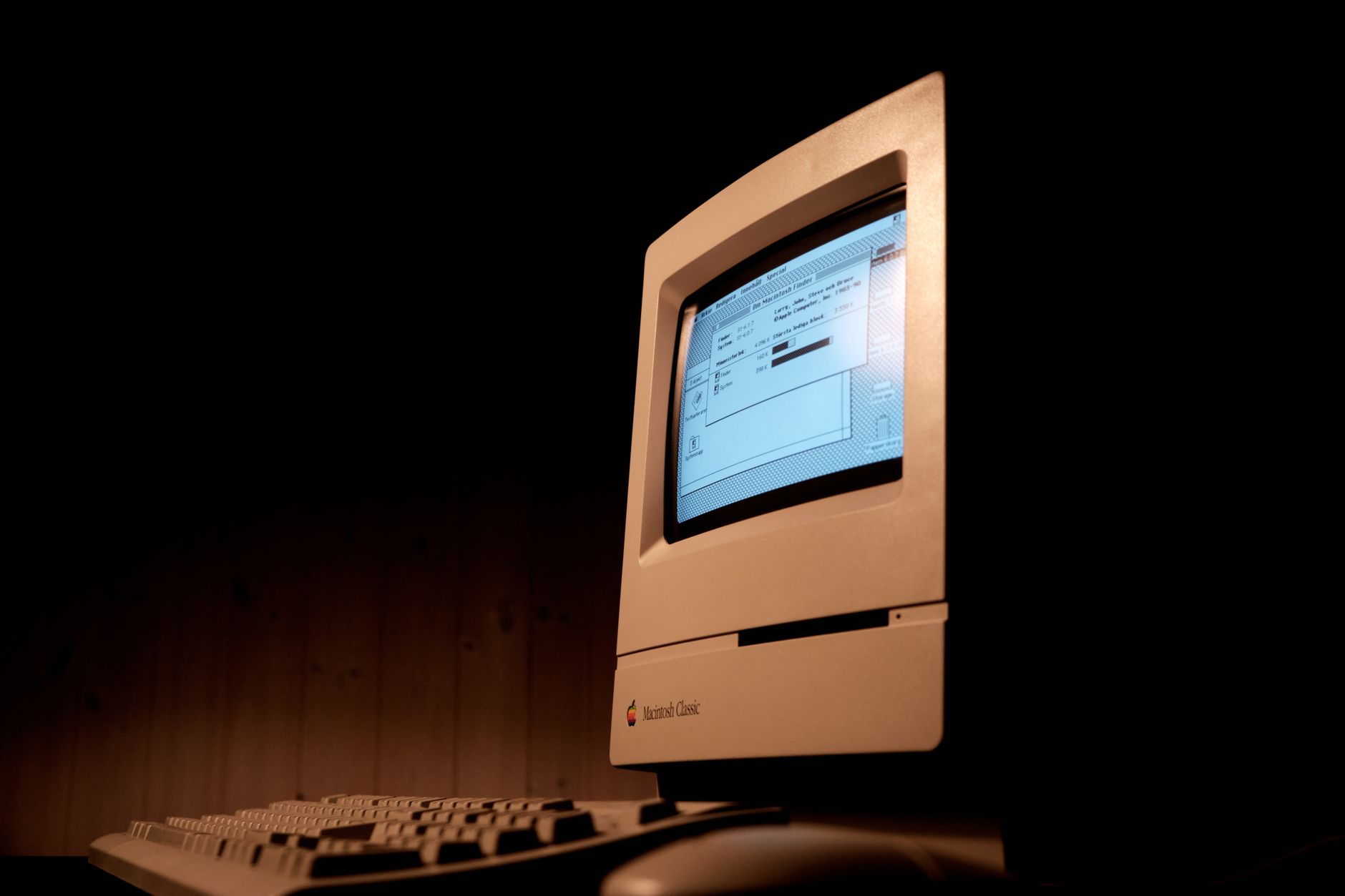Journalist working on an old computer with a CRT monitor in a 1990s newsroom.