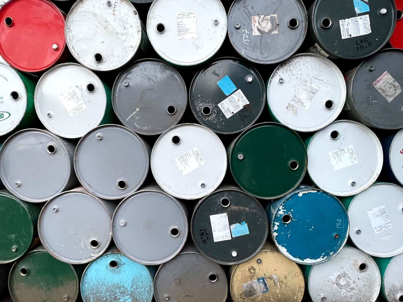 Crude oil barrel with a digital price ticker showing fluctuating numbers in the background of a trading room.