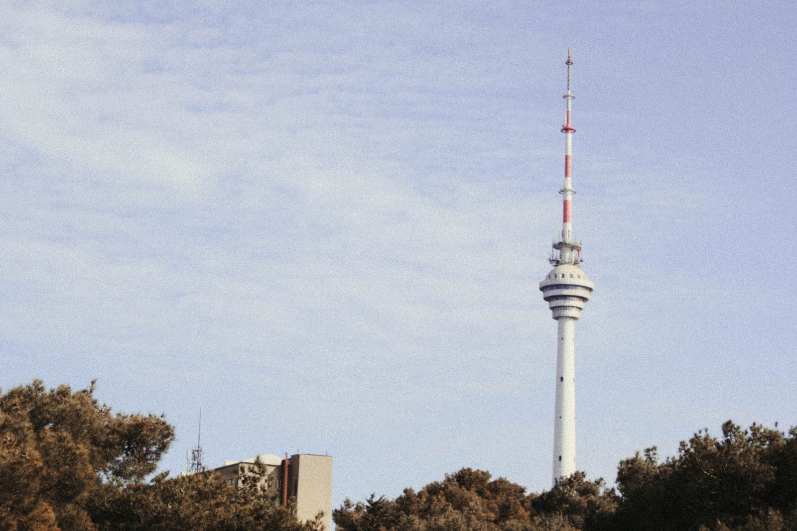 A digital television broadcast tower overlooking Luxembourg City, symbolizing the technological transition.