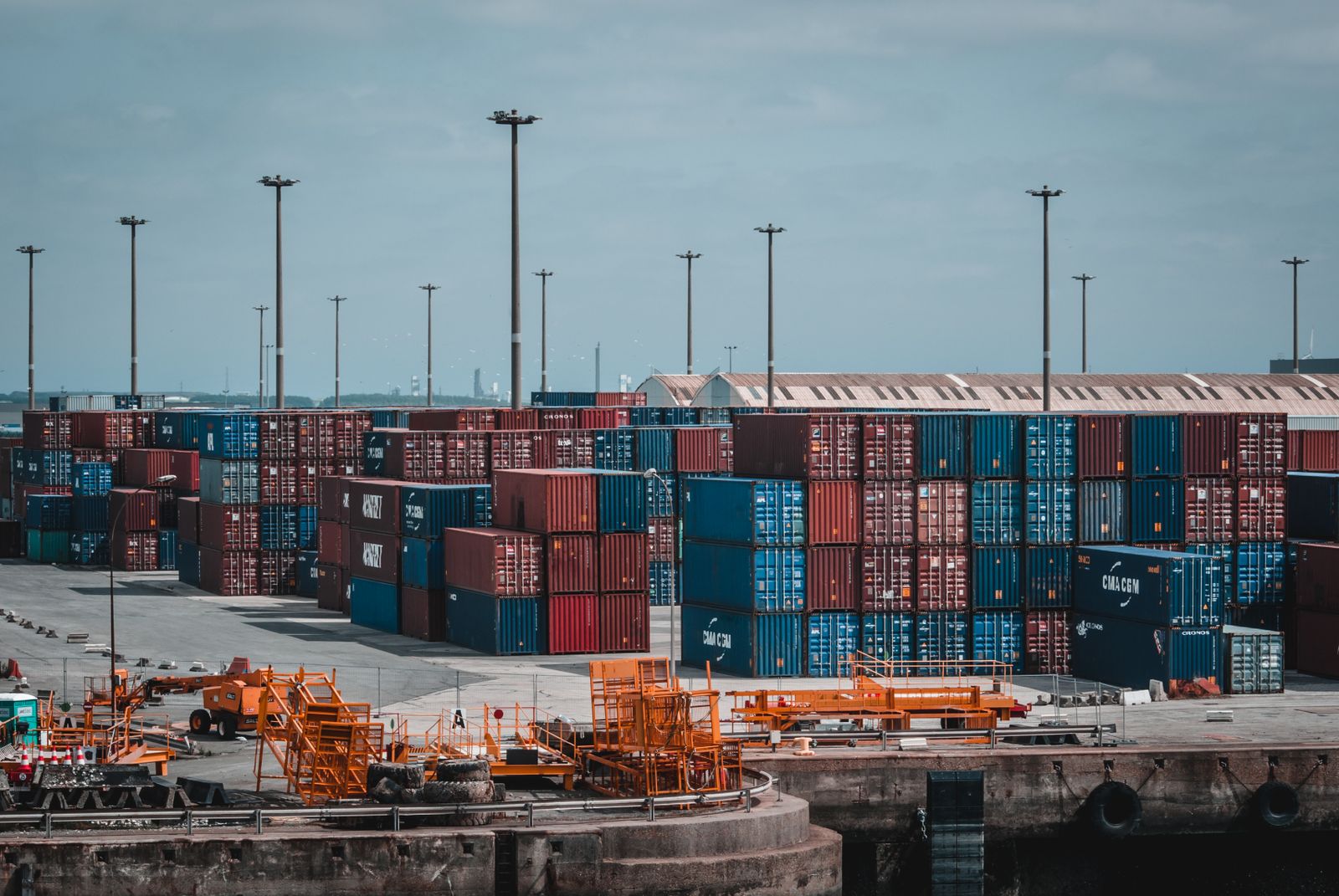 Cargo containers and ships at a global port symbolizing international trade and the economy.