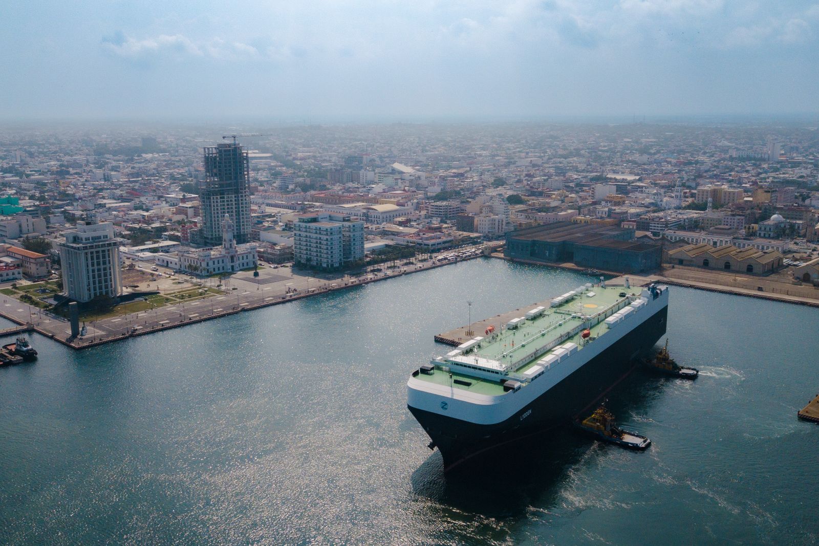 Containers being loaded at a Mexican port representing international trade.