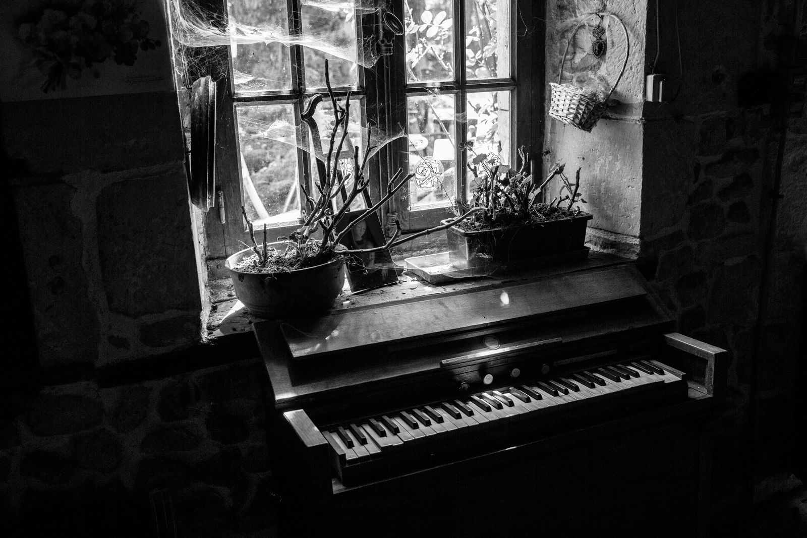 A vintage upright piano in a dimly lit room, evoking a blues house party in Chicago.